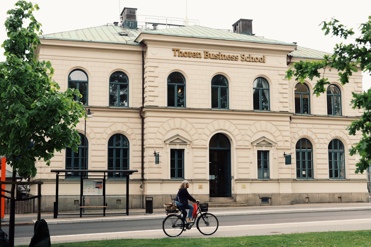 A cyclist passes by the historic Thoren Business School in Jönköping, Sweden.