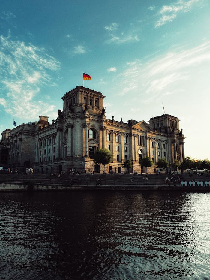Stunning view of the historic Reichstag Building reflecting in the Spree River, Berlin, Germany.